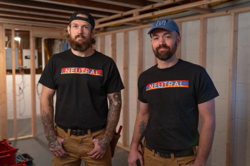 Two Neutral Electricians team members standing in a residential construction space